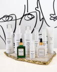 VIBRANT® skincare collection including RESTORE Barrier Repair Moisturizer displayed on marble stone with black and white background