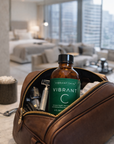 Vibrant Skin bottle in a brown leather toiletry bag with a modern room in the background