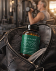 Vibrant Thyroid Support supplement bottle in a leather bag with a gym background