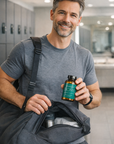 Man holding a bottle of Biome supplements in a locker room.