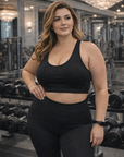 Woman in black athletic wear standing in a gym setting