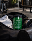 Vibrant Creatine supplement in a gym setting with gym equipment in the background