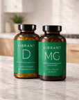 Two bottles of 'Vibrant' supplements on a kitchen counter.