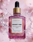 VIBRANT® DESERT VIBE Barrier Hydration Serum bottle submerged in water splash