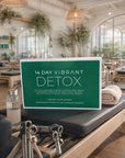 Detox supplement package on a reformer machine in a bright, modern room with plants.