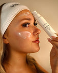 Woman applying VIBRANT® RESTORE Barrier Repair Moisturizer to her face