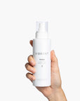 Hand holding Vibrant TONE Clarifying Biome Toner