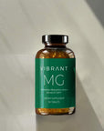 Vibrant MG dietary supplement bottle on a neutral background
