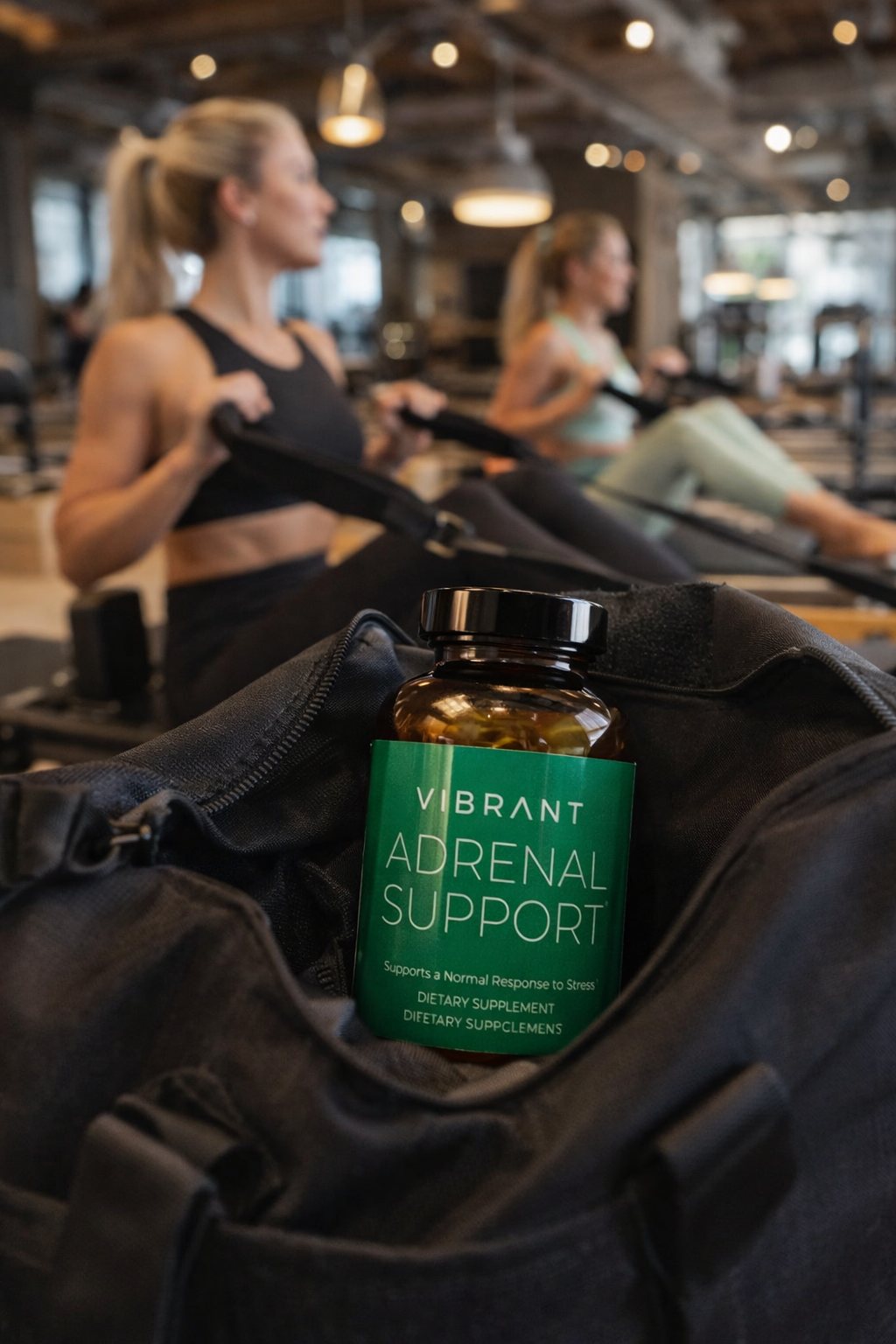 Vibrant Adrenal Support supplement bottle on a jacket with people exercising in the background