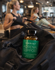 Vibrant Adrenal Support supplement bottle on a jacket with people exercising in the background