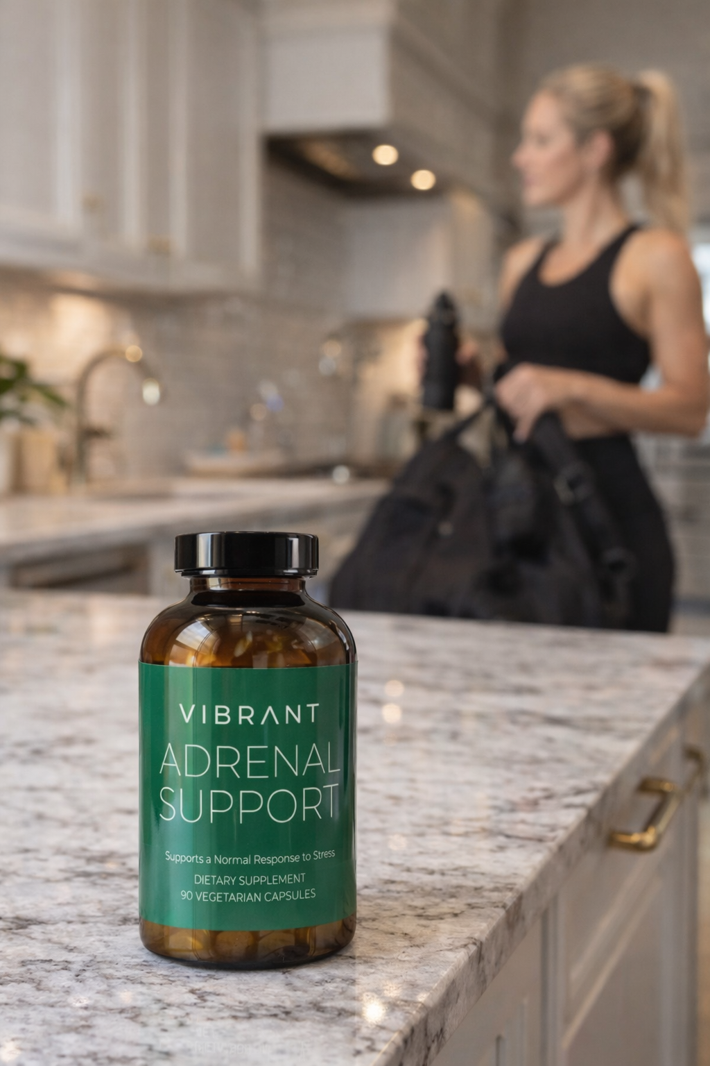 Vibrant Adrenal Support supplement bottle on a kitchen counter with a blurred person in the background.