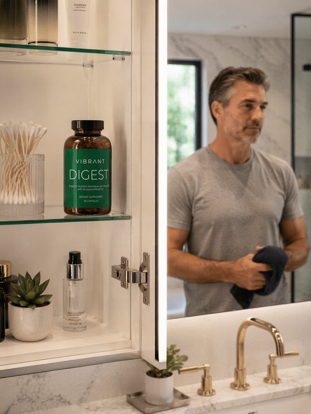 Man standing in a bathroom looking at a cabinet with a bottle labeled 'DIGEST' by Vibrant Health.