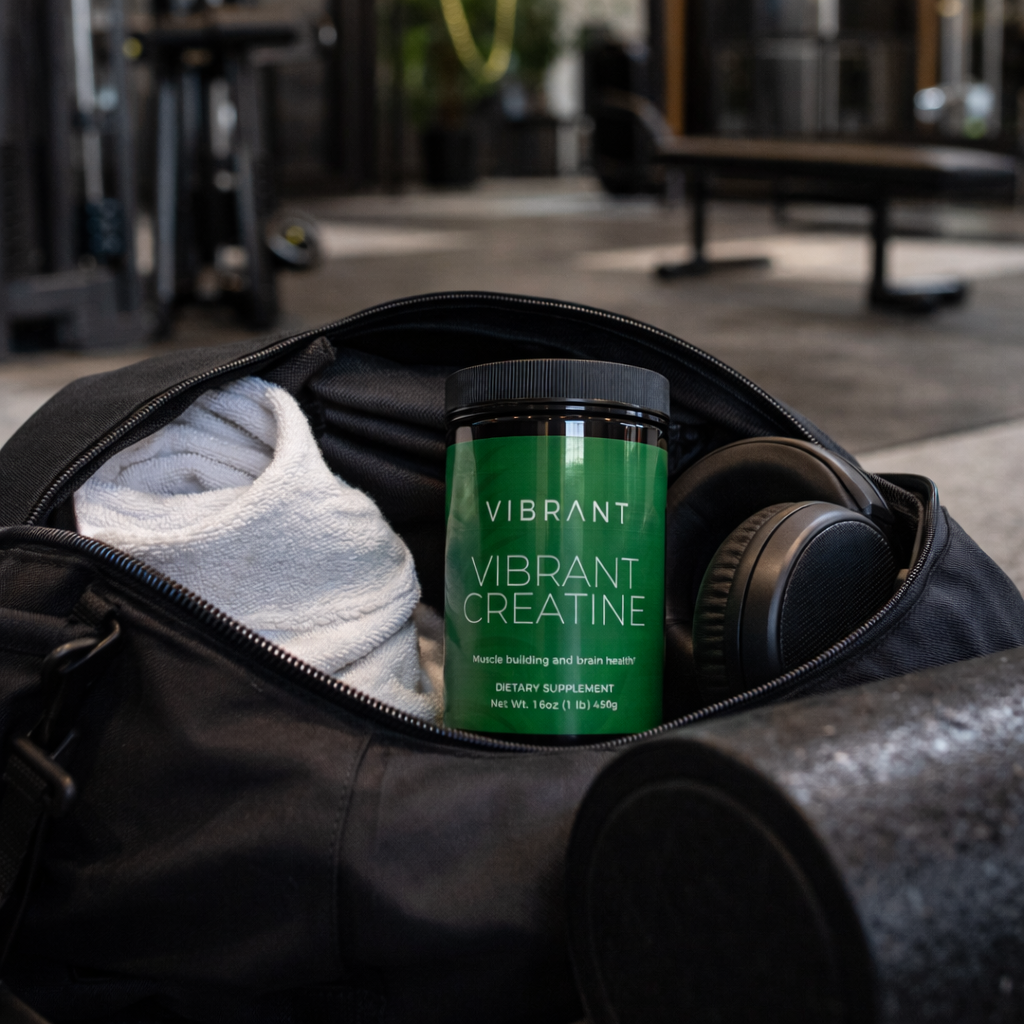 Vibrant Creatine supplement in a gym setting with gym equipment in the background