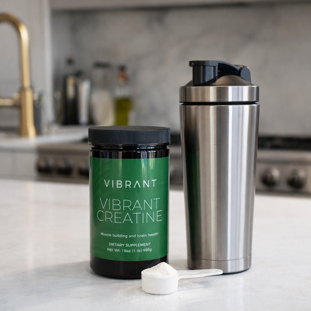 Vibrant Creatine supplement container and shaker on a kitchen counter