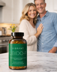 Couple standing in a kitchen with a bottle of Vibrant Libido-F on the counter