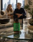 Bottle of Vibrant Brain Health supplement on a glass table with a cityscape in the background