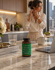 Woman in a kitchen with a bottle of Vibrant Brain Health supplements on the counter.