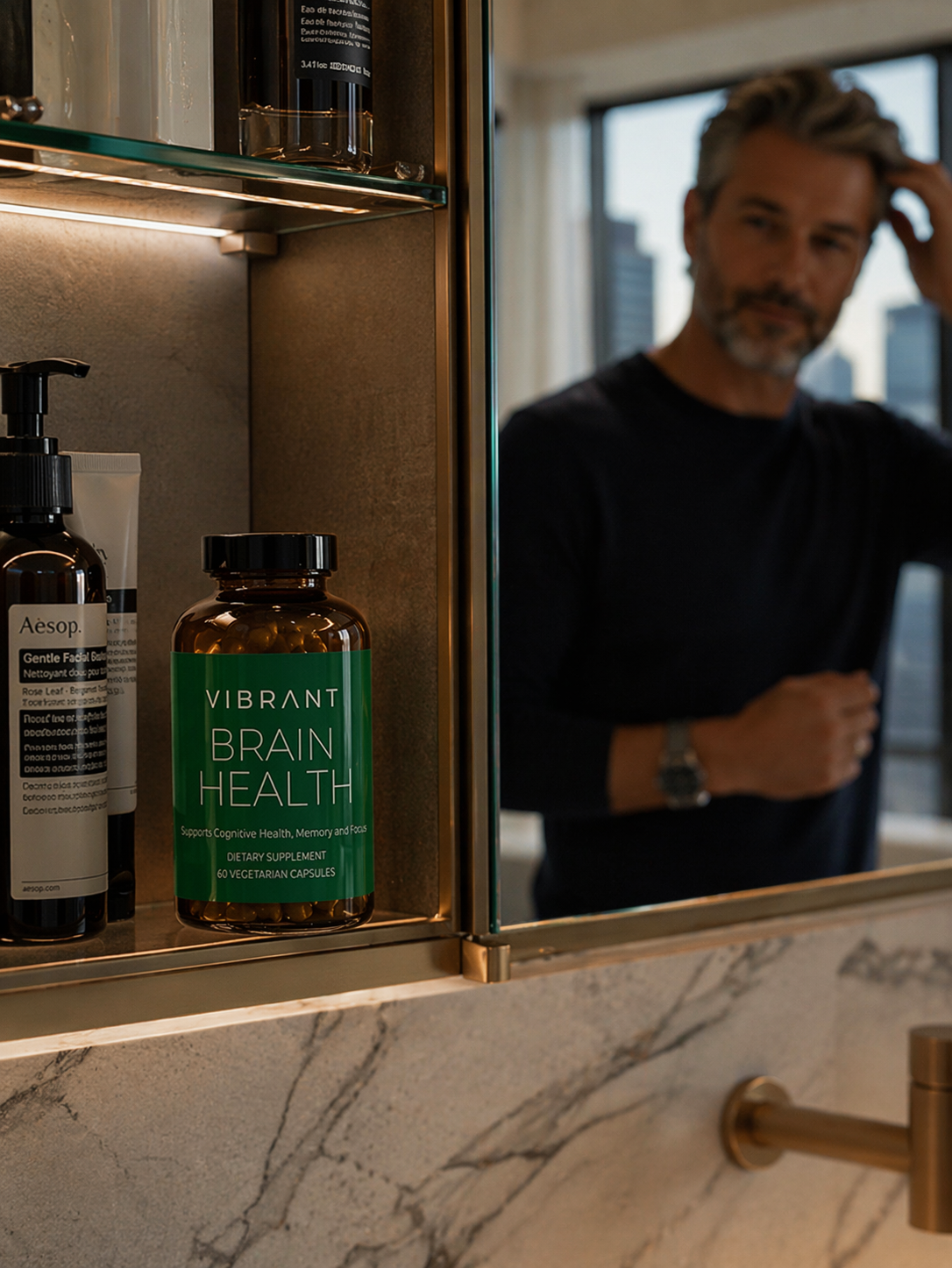 Bathroom counter with a bottle labeled 'Vibrant Brain Health' and a man's reflection in the mirror.